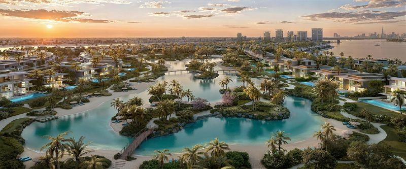 Aerial render of Bay Estate by Nakheel on Dubai Islands: villas around swimmable lagoons at sunset, with the Dubai skyline behind